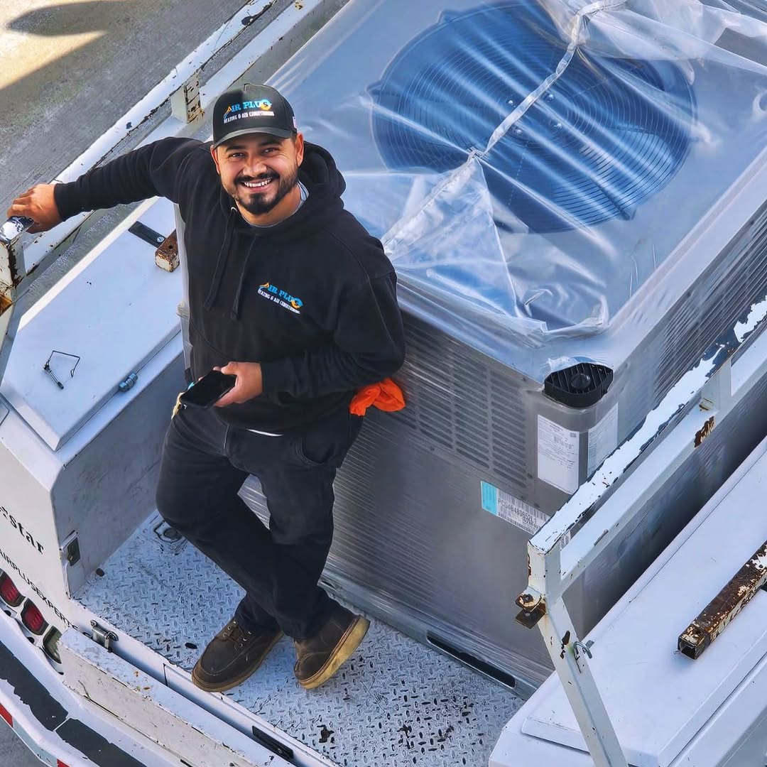 Air Plus technician preparing a new packaged HVAC unit for installation
