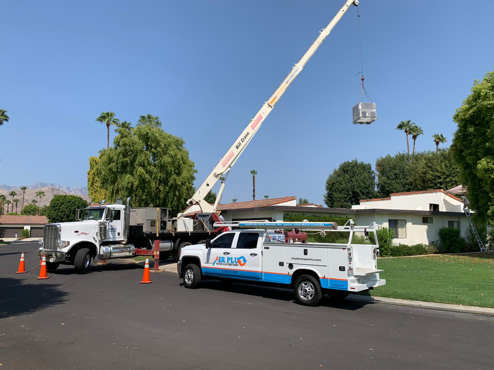 Air Plus truck and crane replacing a rooftop HVAC unit at a Coachella Valley home