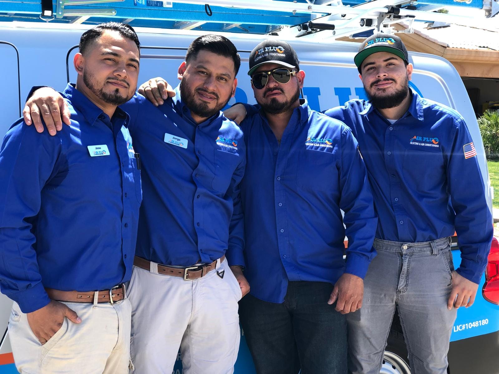 Air Plus Heating & Air Conditioning team of certified technicians standing together in front of a service van.